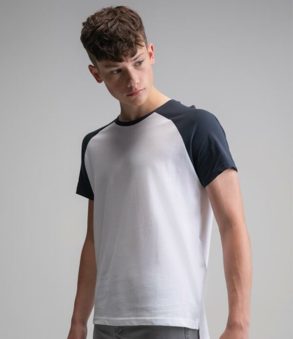 Pure white/dark navy 100% OCS certified organic cotton. Charcoal marl/black 75% OCS certified organic cotton/25% polyester. Washed white/charcoal marl 85% OCS certified organic cotton/15% polyester. Classic fit. Peached finish. Contrast collar. Contrast raglan sleeves. Side seams. Side vents. Drop tail. Twin needle sleeves and hem. Tear out label.