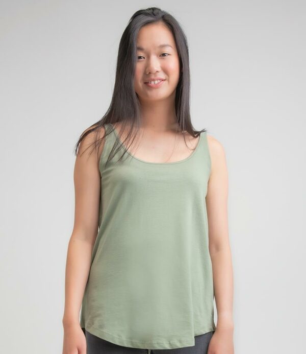 Loose fit. Lower front and back neck. Bound neckline and armholes. Longer length. Twin needle curved hem. Tear out label.