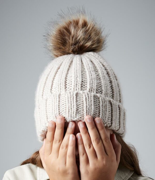 Heavy ribbed knit. Cuffed design. Faux fur pom pom. Non-removable pom pom for added safety. Tear out label.