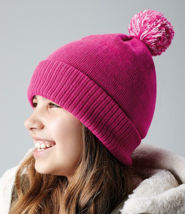 Double layer knit. Dual style - cuffed or slouch. Ribbed cuff. Two tone pom pom.