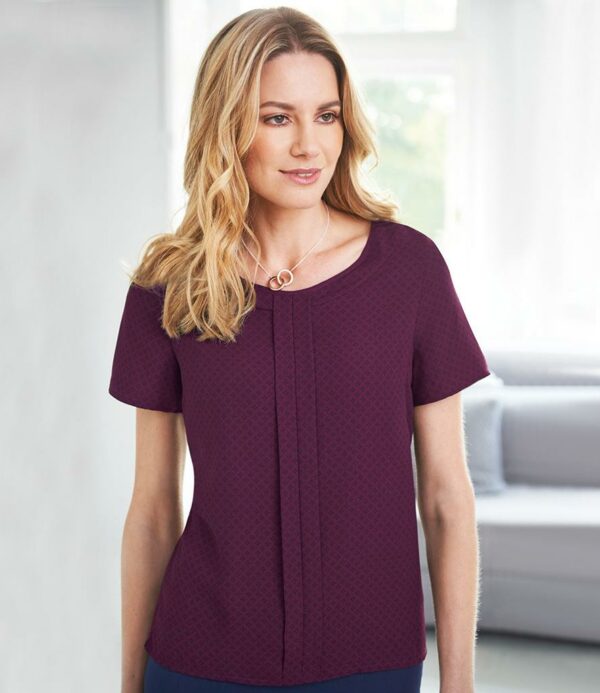 Easy care fabric with mechanical stretch.Round neck.Front pleat detail.Bust darts.Rear gold zip detail.Straight hem.