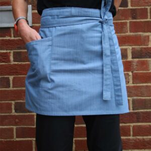 Cross dyed denim.Self fabric ties.Side pocket.Width 71cm.Length 40cm.Domestic wash 60°C.