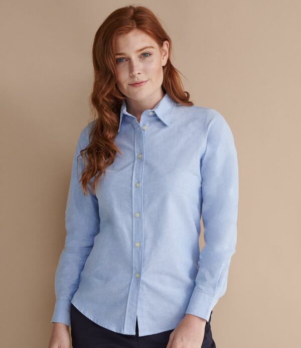 Wrinkle resistant fabric. Ladies fit with shaped side seams. Pearlised buttons. Two button adjustable cuffs. Curved hem.