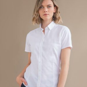Winkle resistant fabric. Ladies modern fit. Short point button down collar. Pearlised buttons. Back yoke. Fitted with darts and shaped side seams. Curved hem. Tag free.