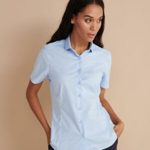 Easy care fabric. Modern ladies fit. Cut away collar. Self colour pearlised buttons. Front and back darts. Curved hem. Cut out label.