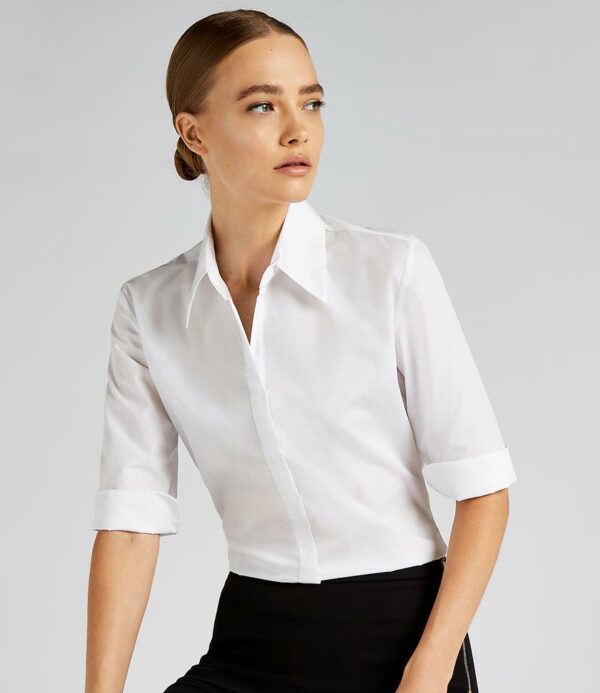 Easy iron fabric.Fused stand up collar.Fitted style with bust and back darts.Pearlised buttons.Concealed placket.3/4 length sleeves with cuff vent.Side vents.Curved hem.