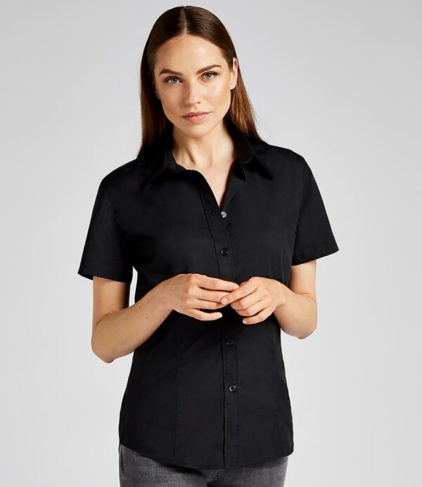 Stand up collar.Optional pocket.Self colour buttons.Back yoke.Front and back darts.Double folded seams.Curved hem.