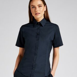 Fused stand up collar.Narrow placket with self colour buttons.Curved panels front and back.Princess seams.Curved hem.Available in long sleeve K743F.