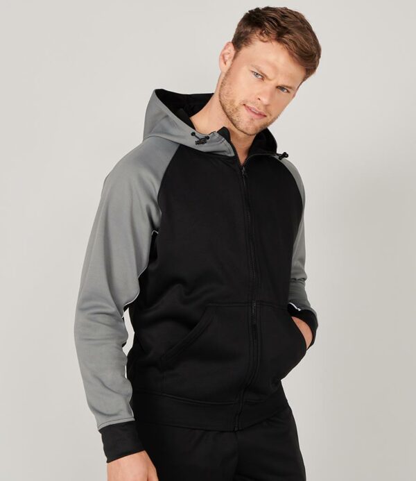 Brushed back fleece. Single jersey lined hood. Funnel neck hood with adjustable toggles. Raglan sleeves. Contrast panelled sleeves with white piping. Full length zip. Front pouch pockets. Ribbed cuffs and hem.
