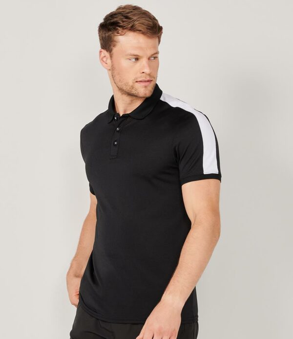 Moisture wicking finish. High stretch fabric. Ribbed collar and cuffs. Taped neck. Three self colour button narrow placket. Contrast shoulder and sleeve panels. Twin needle hem. Tear out label.