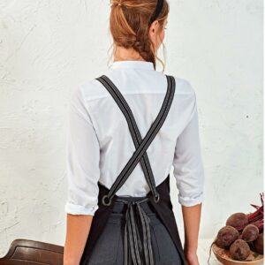 Stripes: 100% polyester.Denim: 70% cotton/30% polyester.Faux Leather: 100% polyurethane.Fixed with a dungaree style buckle closure to hook onto the main body of the apron.Width 3cm.Length 170cm.The straps are designed to cross over at the back