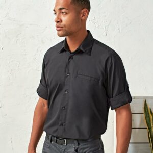 Easy care fabric. Formal cut collar. Roll-up sleeves with button and tab. Double folded seams. Left chest vented jet pocket. Self colour buttons. Back yoke. Adjustable cuffs. Straight hem.