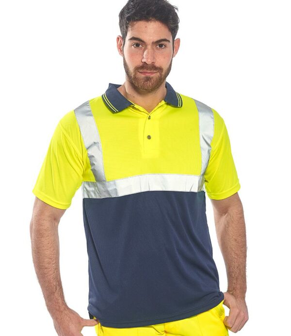 Conforms to EN ISO 20471: 2013 + A1: 2016 class 1.ANSI/ISEA 107 class 1:2.UPF 35+.Breathable moisture wicking fabric.Contrast ribbed collar with fluorescent stripes.Three button placket.Reflective band around the body and one over each shoulder.Contrast lower body.Side vents.Twin needle stitching.