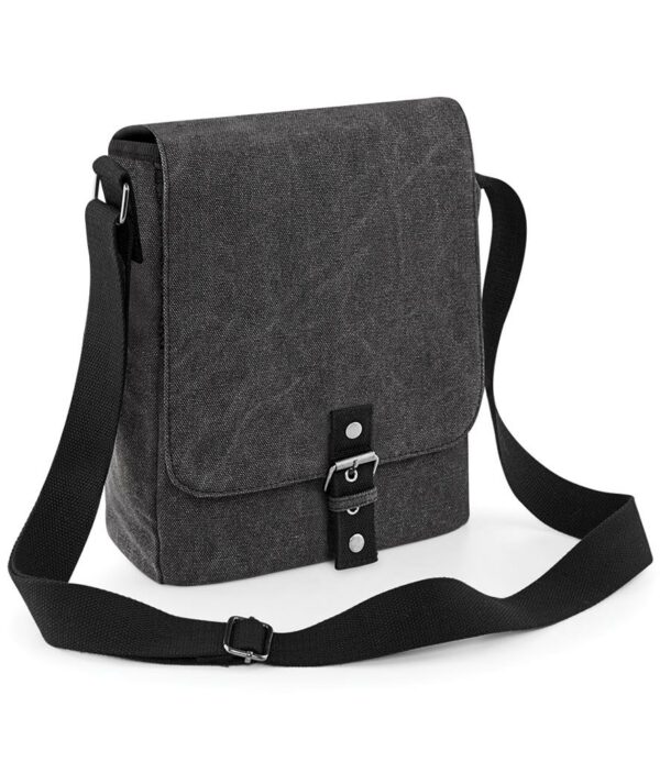 Adjustable shoulder strap. Magnetic closure. Rear zip pocket. Mesh zip pocket under flap. Padded internal iPad®/Tablet compartment. Capacity 5 litres.