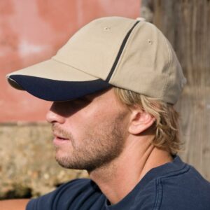 6 panel. Stitched eyelets. Contrast scallop peak and trim. Fabric size adjuster with polished metal buckle.