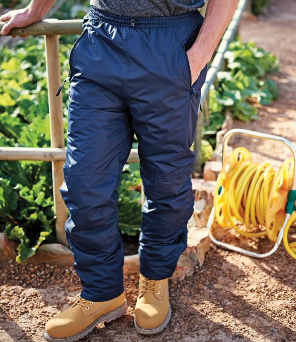 Thermo-Guard® insulation. Waterproof with taped seams. Windproof and breathable. Elasticated waistband with drawcord. Two side zip pockets. Protective overlays to knees and seat area. Adjusters at ankle.