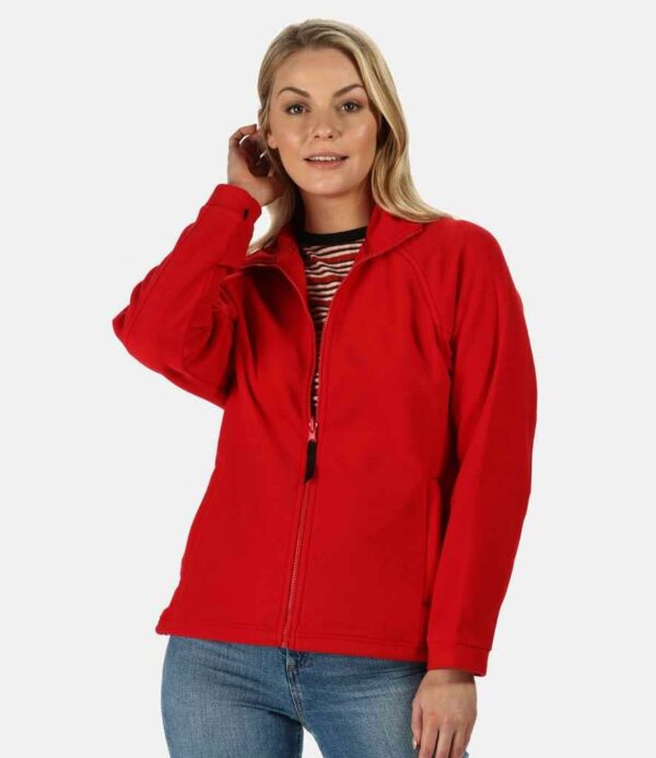 Unlined. Shaped fit. Taped neck. Locker patch. Raglan sleeves. Full length zip. Two front zip pockets. Fleece cuffs. Adjustable drawcord hem. Double stitch detail. Cut out label.
