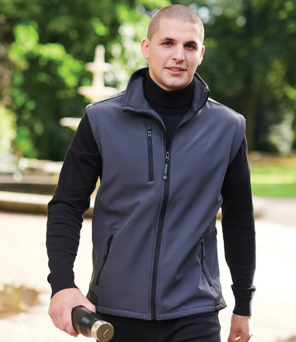 96% polyester/4% elastane. Hardwearing warm backed woven stretch ripstop soft shell fabric. ATL durable water repellent finish. Durazone polyamide overlays at wear points for added strength and durability. Reflective trim on shoulders. Full length zip with chin guard and inner zip guard. Right chest zip pocket. Two front zip pockets. Adjustable drawcord hem. Branding on back of collar/no branding. Cut out label (some colours in transition).