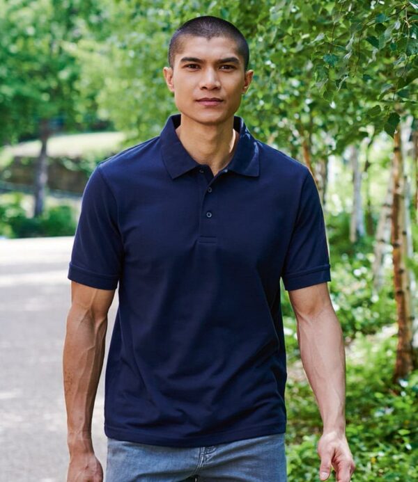 Airflow construction promotes cooling. Ribbed collar and cuffs. Three button placket. Twin needle hem. Cut out label.