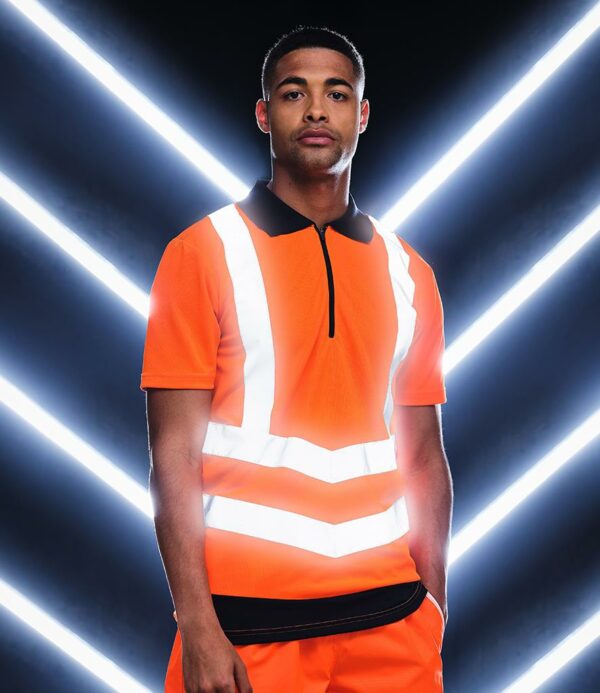Conforms to EN ISO 20471: 2013 + A1: 2016 class 2. RIS-3279-TOM (orange/navy only). Quick drying with natural wicking properties. Contrast ribbed collar. Black zip neck. Two angled ID reflective tape bands around the body and one over each shoulder. Twin needle stitching. Cut out label.