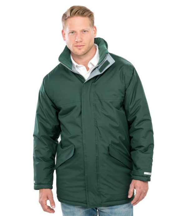 Quilted polyester lining. Waterproof 2000mm with taped seams. Windproof. Concealed adjustable hood. Full length zip with tear release storm flap. Two front pockets with storm flaps and fleece lining. Inside pocket. Inner elasticated cuffs and reflective cuff detail. Adjustable drawcord hem. Cut out label. Access for decoration.