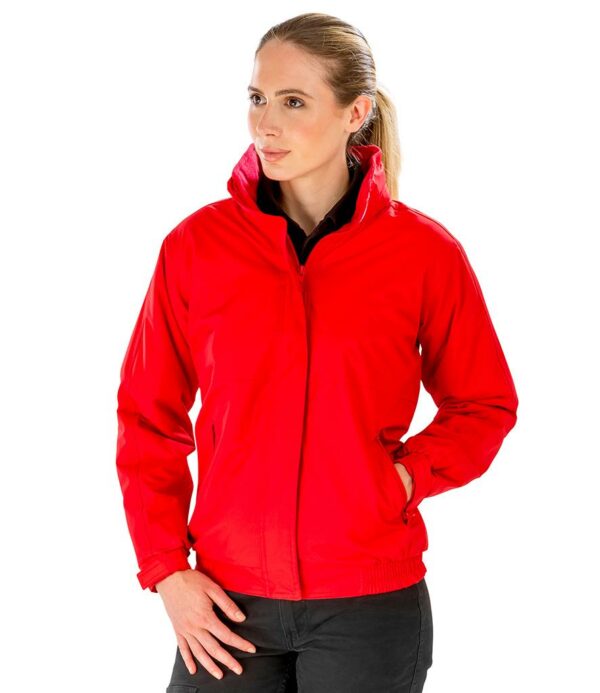 Fleece lined body and polyester lined sleeves. Waterproof with taped seams. Windproof. Concealed adjustable hood. Full length zip with tear release storm flap. Two front zip pockets. Inner media pocket. Part elasticated adjustable cuffs. Part elasticated hem. Cut out label. Access for decoration.