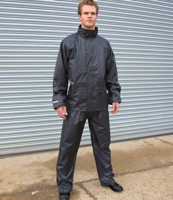 Waterproof 2000mm with taped seams. Windproof. Integrated concealed elasticated hood. Full length zip with studded storm flap. Mesh ventilation panel on back. Ventilation underarm eyelets.  Inner elasticated storm cuffs. Reflective trim on cuffs. Trousers have elasticated waistband. Two front pockets. Slit access to pockets. Open leg ends with snap adjusters. Cut out label.