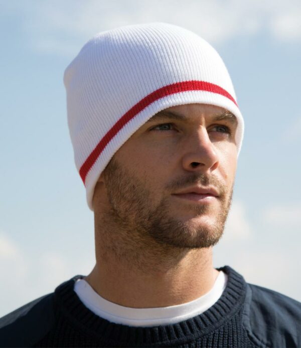 Windproof. 6 gauge knit. Stripe knit in national colourways. Solid colour inner.